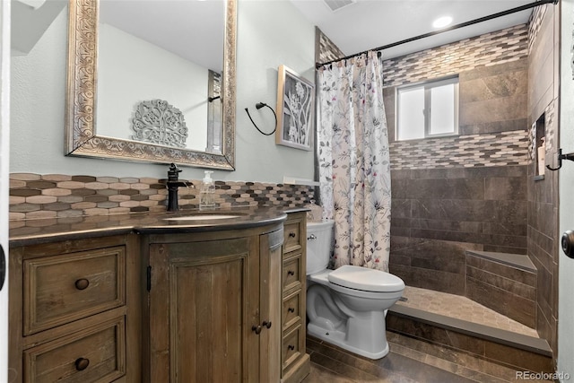 bathroom with vanity, a shower with curtain, decorative backsplash, and toilet