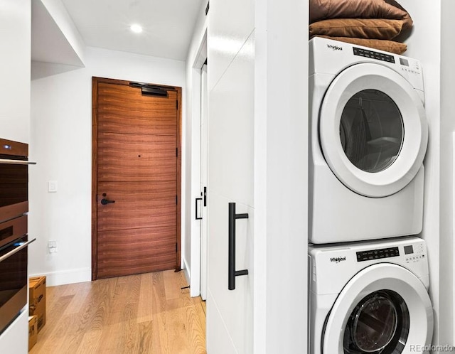1901 Wazee St Unit 419, Denver, CO 80202 - laundry room with stacked washer / drying machine, light wood finished floors, and recessed lighting