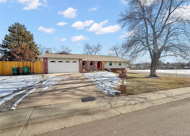 ranch-style home featuring brick siding, fence, driveway, a garage, and a chimney