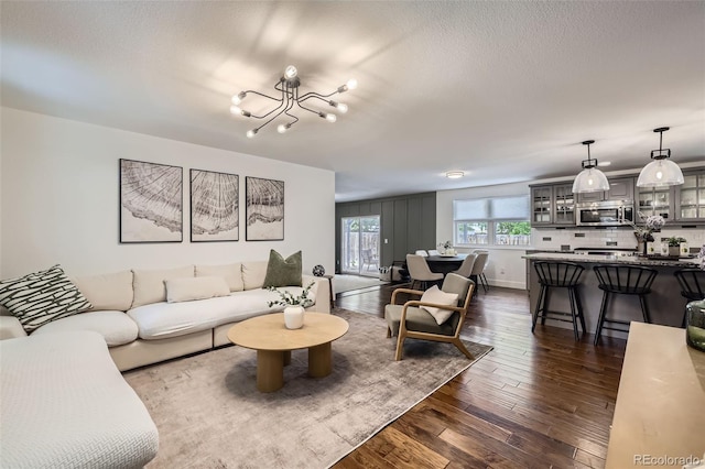 7746 S Gray St, Littleton, CO 80128 - living area with a chandelier, dark wood-style floors, and a textured ceiling