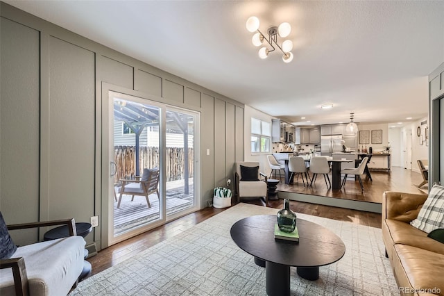 7746 S Gray St, Littleton, CO 80128 - living room featuring wood finished floors and a decorative wall