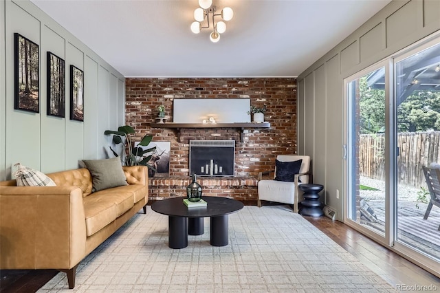 7746 S Gray St, Littleton, CO 80128 - living room with a decorative wall, wood finished floors, and a brick fireplace