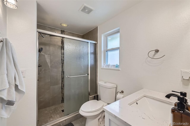 7746 S Gray St, Littleton, CO 80128 - full bathroom with a shower stall, toilet, vanity, and tile patterned flooring