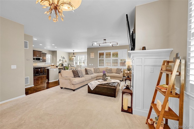 living room featuring dark carpet, recessed lighting, a chandelier, and visible vents