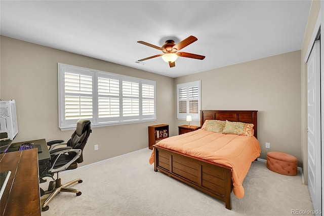 carpeted bedroom featuring a ceiling fan, baseboards, and a closet