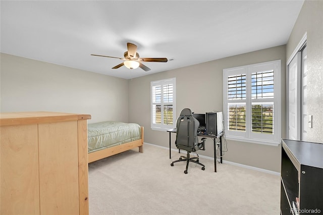 bedroom with baseboards, ceiling fan, and light carpet