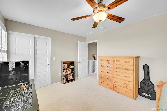 bedroom with visible vents, a ceiling fan, and light colored carpet