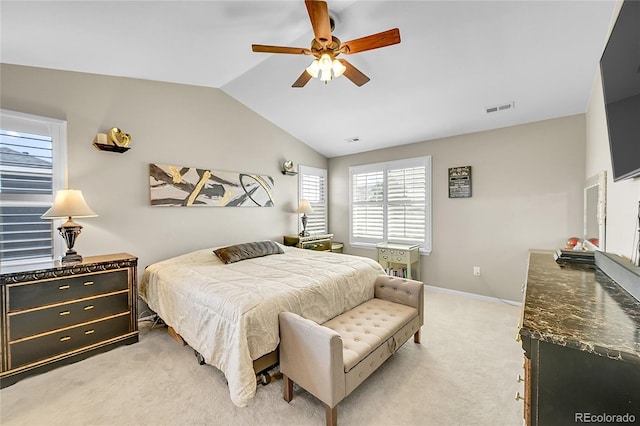 bedroom featuring ceiling fan, light colored carpet, visible vents, vaulted ceiling, and baseboards