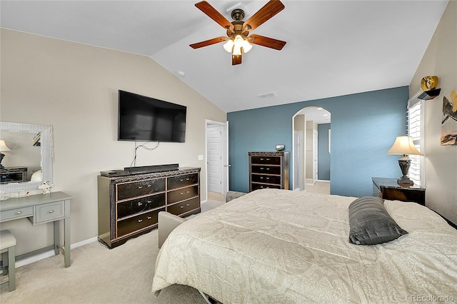 bedroom featuring light carpet, visible vents, arched walkways, a ceiling fan, and vaulted ceiling