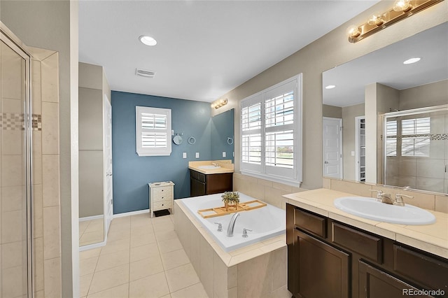 bathroom featuring a sink, tile patterned flooring, visible vents, a garden tub, and a stall shower