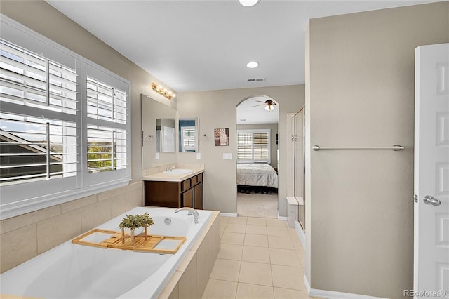 ensuite bathroom with a ceiling fan, a garden tub, visible vents, tile patterned floors, and ensuite bath