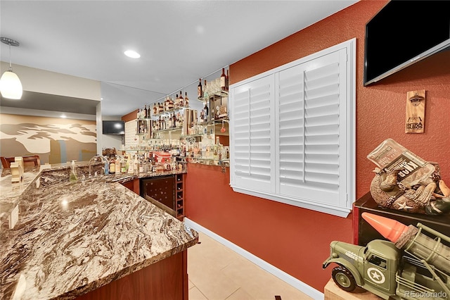 bar featuring wine cooler, light tile patterned flooring, indoor wet bar, a sink, and decorative light fixtures