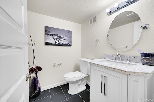 half bath with visible vents, tile patterned flooring, vanity, baseboards, and toilet