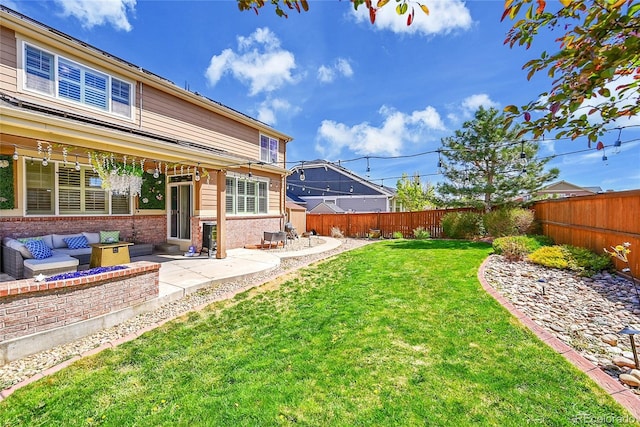 view of yard with an outdoor living space, a fenced backyard, and a patio area