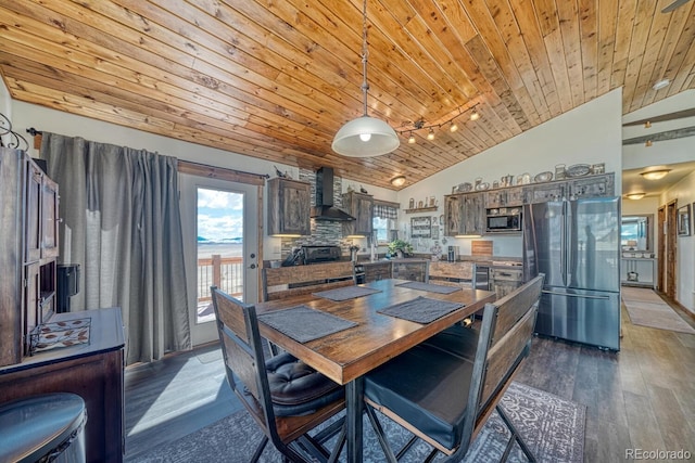 7103 Ranch Rd, Hartsel, CO 80449 - kitchen with freestanding refrigerator, lofted ceiling, wall chimney range hood, wood ceiling, and dark wood-style floors