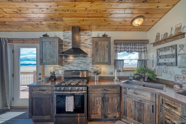 7103 Ranch Rd, Hartsel, CO 80449 - kitchen with stainless steel gas stove, wall chimney exhaust hood, a sink, wooden ceiling, and backsplash