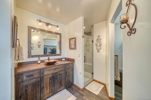 7103 Ranch Rd, Hartsel, CO 80449 - full bathroom with wood finished floors, a stall shower, vanity, and baseboards