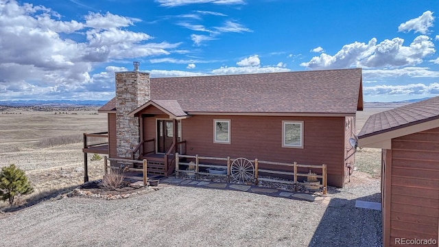 7103 Ranch Rd, Hartsel, CO 80449 - chalet / cabin featuring roof with shingles, a chimney, and fence