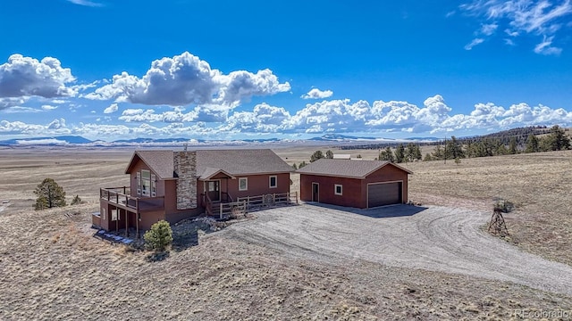 7103 Ranch Rd, Hartsel, CO 80449 - back of house with an outbuilding, a garage, a mountain view, and stone siding