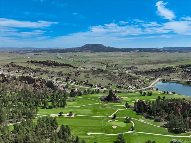 aerial view of property and surrounding area with a water and mountain view and a golf club