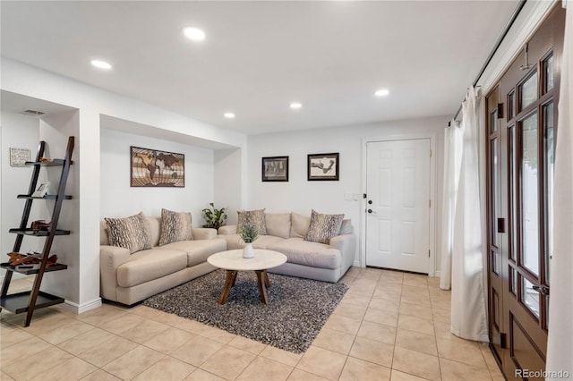 living area with recessed lighting, light tile patterned flooring, and baseboards