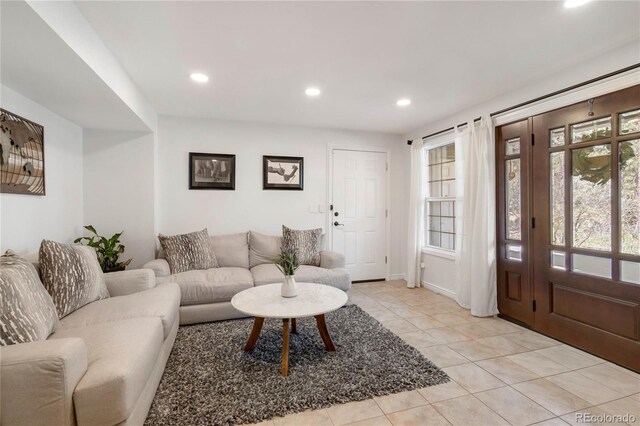 living area with light tile patterned flooring, recessed lighting, and baseboards