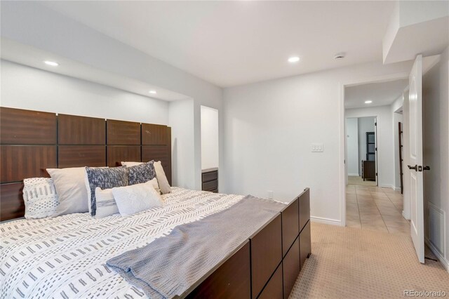 bedroom featuring recessed lighting, light colored carpet, light tile patterned floors, and baseboards