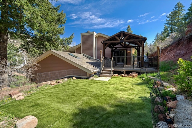 rear view of property featuring a chimney and a deck