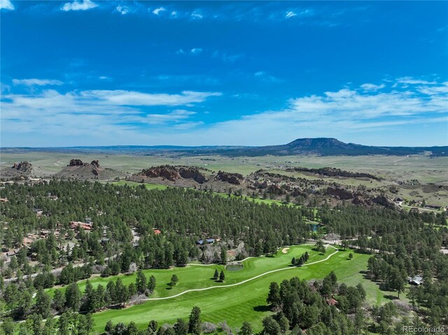 aerial overview of property's location with a mountainous background and a golf club