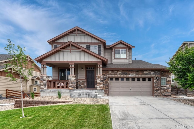 22583 E Union Cir, Aurora, CO 80015 - craftsman-style home featuring covered porch, concrete driveway, stone siding, and a front lawn