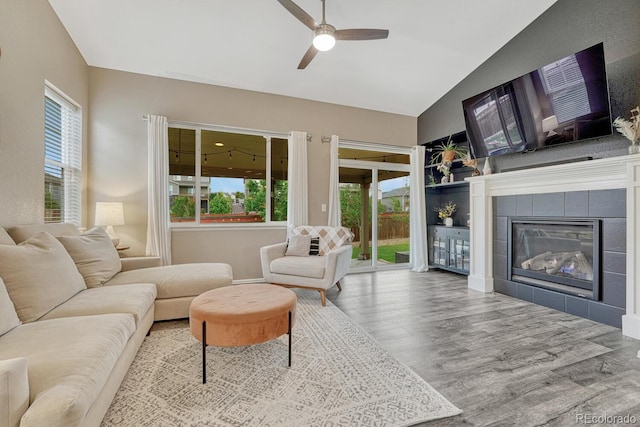 22583 E Union Cir, Aurora, CO 80015 - living area featuring a ceiling fan, lofted ceiling, wood finished floors, and a fireplace