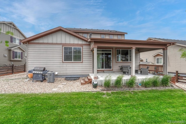 22583 E Union Cir, Aurora, CO 80015 - back of property with a patio area and board and batten siding