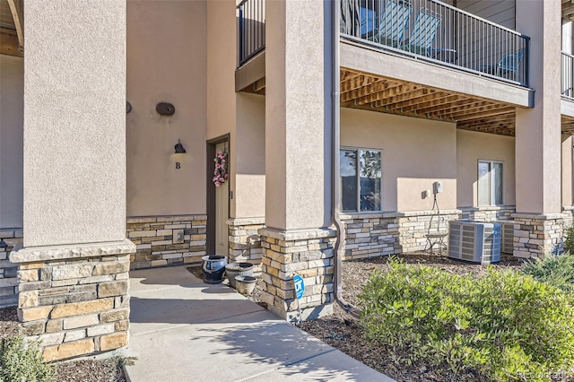 doorway to property featuring central air condition unit and a balcony