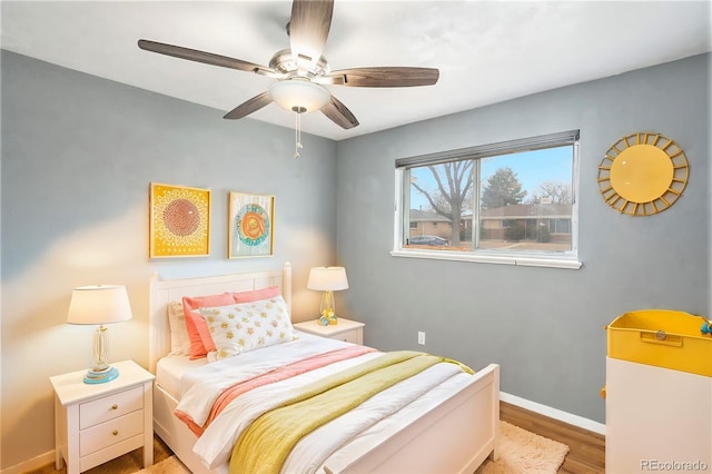 bedroom featuring a ceiling fan, wood finished floors, and baseboards