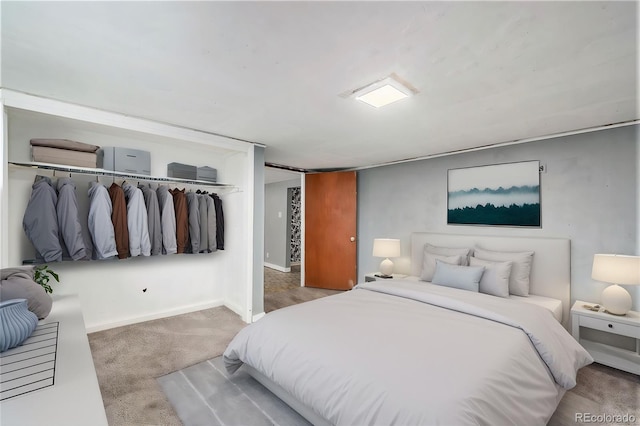 carpeted bedroom featuring baseboards and a closet