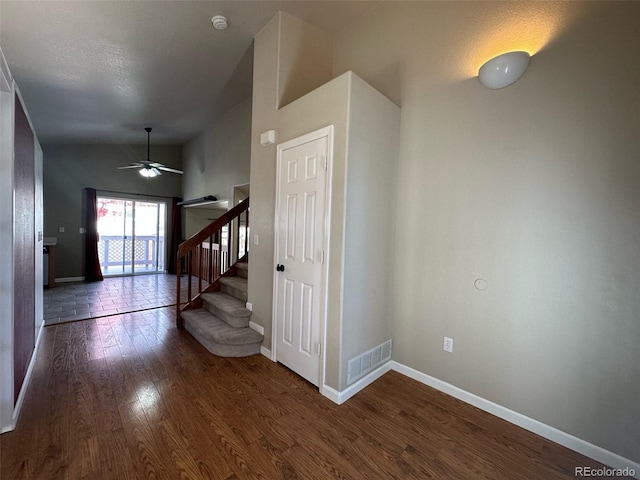 hall featuring lofted ceiling and dark hardwood / wood-style flooring