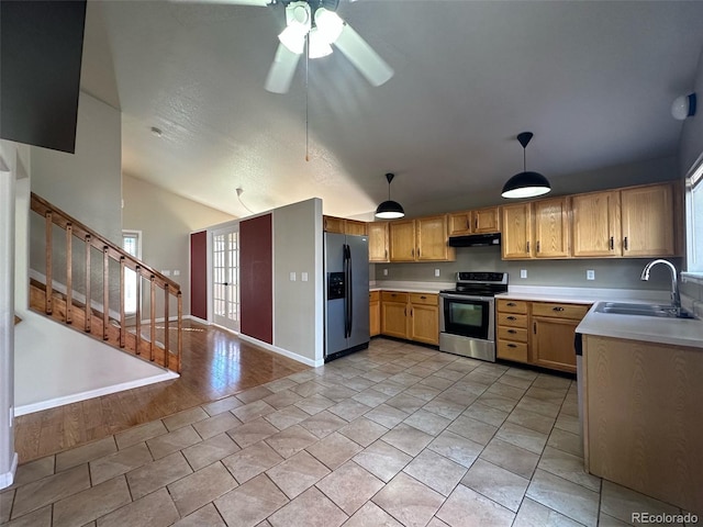 kitchen featuring hanging light fixtures, ceiling fan, stainless steel appliances, light tile floors, and sink