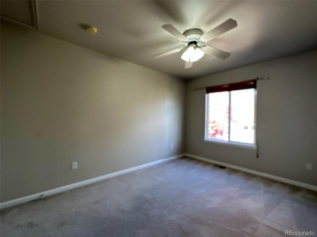 empty room with ceiling fan and carpet