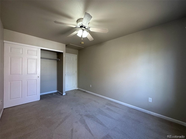 unfurnished bedroom featuring ceiling fan, a closet, and dark colored carpet