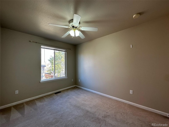 empty room with carpet flooring and ceiling fan