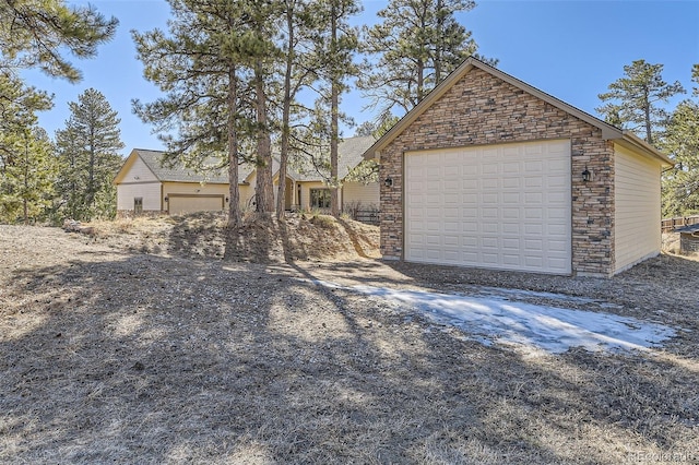 view of front of home with a garage and an outdoor structure