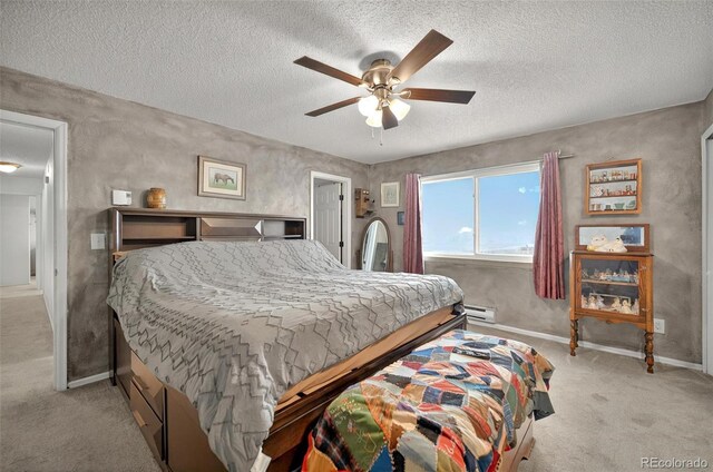 bedroom with light carpet, a baseboard radiator, a textured ceiling, baseboards, and ceiling fan