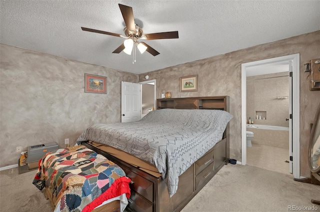 carpeted bedroom featuring a textured ceiling, ceiling fan, ensuite bathroom, and baseboards