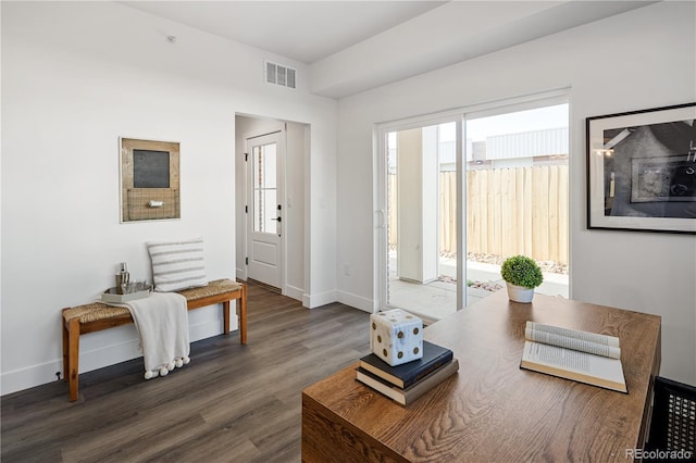 entryway with wood finished floors, baseboards, and visible vents