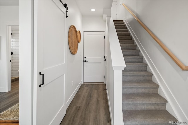 stairway featuring recessed lighting, baseboards, and wood finished floors