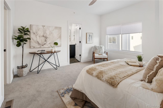bedroom featuring connected bathroom, a ceiling fan, visible vents, carpet floors, and baseboards