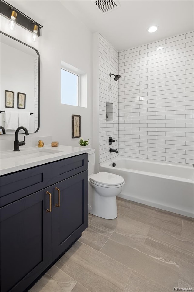 bathroom with visible vents, toilet, bathtub / shower combination, recessed lighting, and vanity