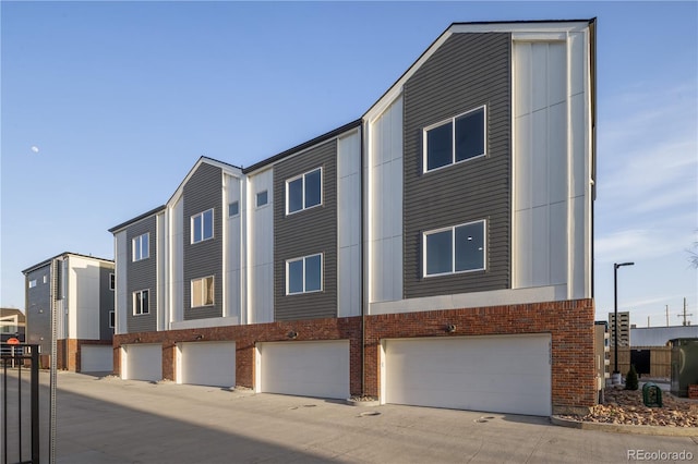 exterior space featuring brick siding and a garage