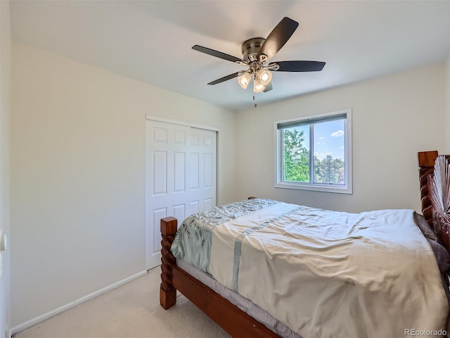 carpeted bedroom featuring ceiling fan and a closet