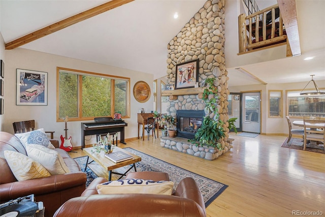 31755 Ponderosa Way, Evergreen, CO 80439 - living room with wood finished floors, high vaulted ceiling, a fireplace, beam ceiling, and recessed lighting